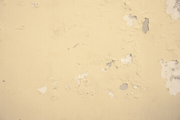 Light color paint peeling from the wall. Moisture damage. Texture