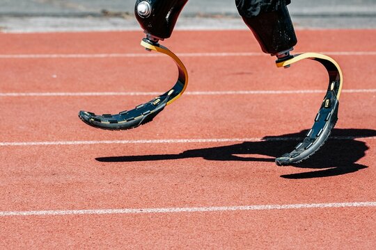 Man paralympic athlete running with prosthetic legs - Powered by Adobe