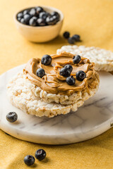 Peanut butter and rice cakes sandwich. Healthy protein snack.