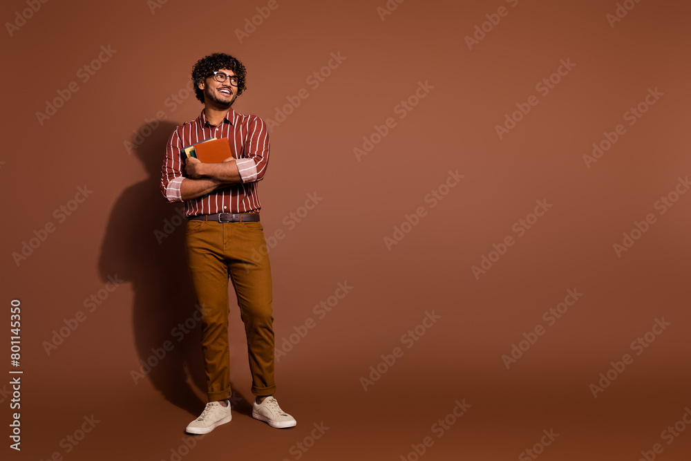 Canvas Prints Full size photo of nice young man book look empty space wear striped shirt isolated on brown color background