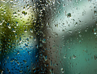 water drops on glass the melancholy mood of a rainy day. with raindrops on a window. Abstract 