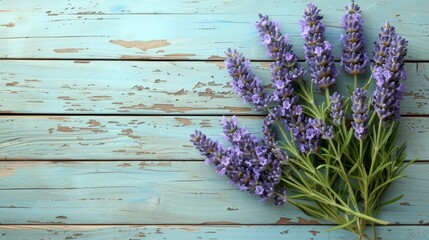   A table with a blue wooden surface holds several lavender blooms and a vase filled with flowers nearby