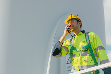 professional engineer male working outdoor with safety at wind turbines clean energy power station background, worker people with renewable energy technology for future concept. - 801166331