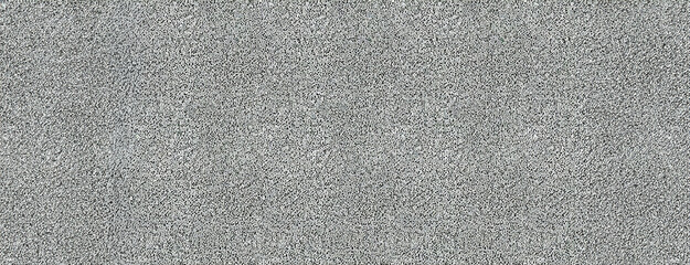 Grey Granular Surface or background. Granularity showcased in varying shades of gray and white colors. Panorama with copy space.