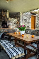 Rustic Outdoor Stone Dining Area, Set Against the Tranquil Backdrop of a Cozy Country House 