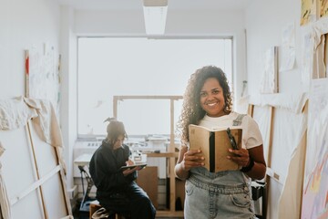 Woman artist reading and studying in her studio