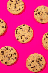 Fresh cookies with chocolate chips on a pink background. Dessert, a pastry shop. Pattern. 
