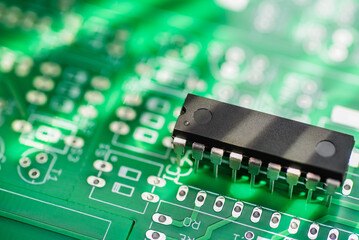 Close-up view of an integrated circuit on a green printed circuit board