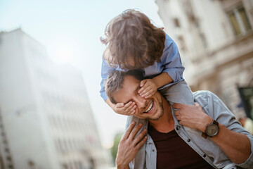 Playful father and son having fun in the city