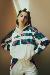 Young beautiful girl standing confidently in stylish 90s inspired tracksuit, trendy makeup and...