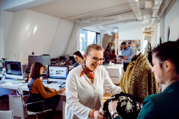 Two fashion designers working together on a project in a design studio