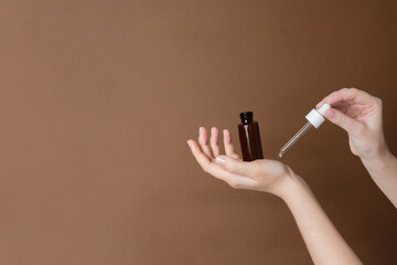 Serum glass bottle or essential oil with pipette. Natural moisturizing, nourishing cosmetics for...