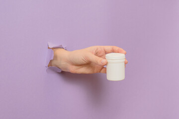 Cosmetic container in female hand. Cosmetic beauty packaging