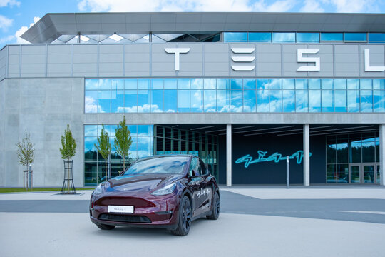 cherry red Tesla model y electric car front Gigafactory Berlin-Brandenburg, Automotive industry in Europe, sustainable and efficient facility yet, Berlin, Germany - April 26, 2024