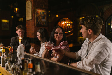 Man and woman cheers glasses with beverages celebrating meet in bar. Happy guests clink alcohol...