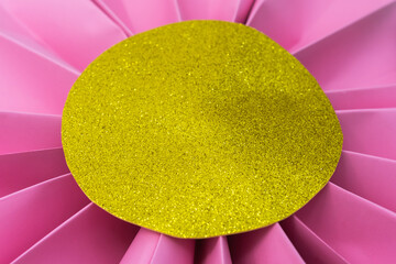 Folded pink paper flower with gold glitter center. Crafts for decoration. - obrazy, fototapety, plakaty