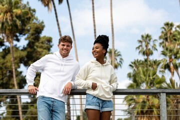 Couple in casual wear apparel, chilling in  a park