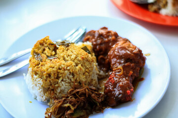 Nasi Kandar with red fried chicken as a side dish