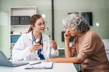 Fototapeta premium Caucasian female psychiatrist sits at her desk, providing mental health consultations and therapy sessions to her patients with empathy and expertise.