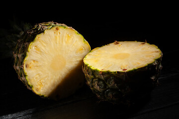 sliced pineapple on black wood background - 801203917