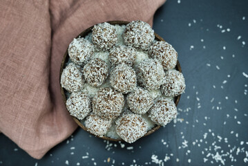 Coconut Covered Energy Balls on Dark Background