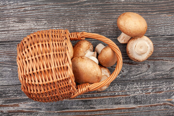 brown mushroom basket on wood background top view