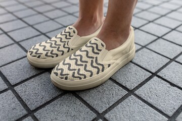 Abstract wave pattern sneaker, women's casual footwear on grey tiled floor