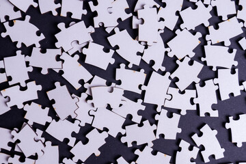white deconstructed puzzles on a colored background
