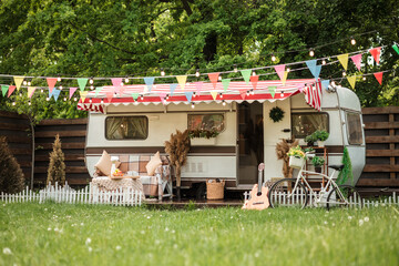 Camping season. Photo studio. Bicycle on the background of the trailer. Summer, green grass, recreation for people.