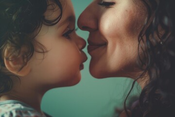 Mother kissing her daughter's face, Mother's Day concept.