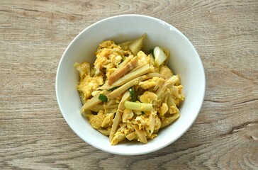 stir fried bamboo shoot and egg with spring onion on bowl