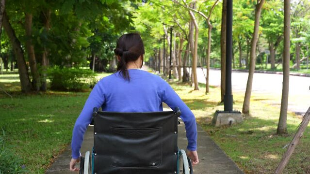 Happy young woman in wheelchair park outdoors, gorgeous positive girl in wheelchair rejoicing at new day, positive feeling and emotion. cheerfulness, physical recovery concept