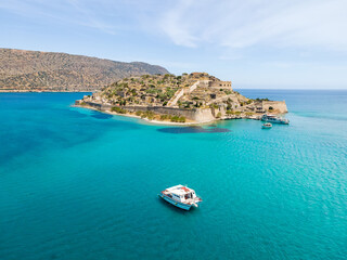 Aerial drone view of Spinalonga island with calm sea. Old venetian fortress island and former leper...