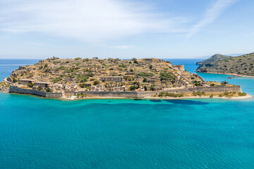 Fototapeta premium Aerial drone view of Spinalonga island with calm sea. Old venetian fortress island and former leper colony.