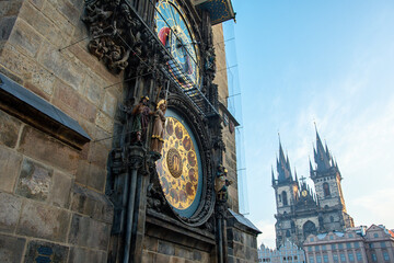 Astronomical clock in Old Town of Prague with Tyn church.