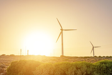 Wind turbines with sunny mountain landsape. Green power generation concept.