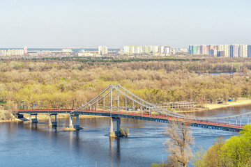 Fototapeta premium Landscape view of city with a bridge in Kyiv, Ukraine.