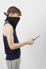 A teenage mugger holding a knife