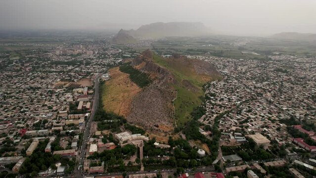 Aerial view of Sulaiman Too Sacred Mountain in Osh city, Kyrgyzstan. The symbol of the city of Osh. Beautiful powerful mountain