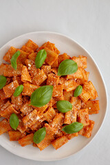 Homemade Vodka Rigatoni Pasta with Parmesan Cheese and Basil, top view. Copy space.