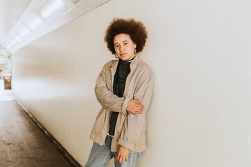 African American woman posing by the wall