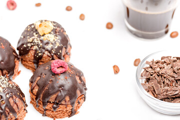 Round chocolate cakes. Decorated with candied raspberries. Light background.