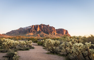Evening photo of a hiking trail leading to Superstition Mountain in the distance outside of phoenix...