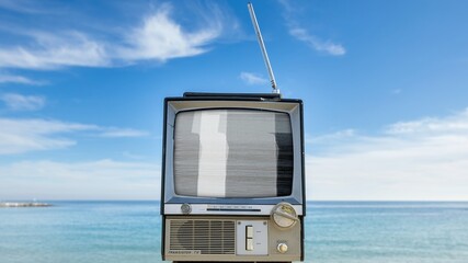 television with glitch next to the sea - 801247159