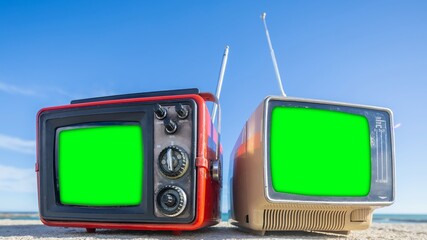 televisions with green screen next to the sea, to add your own content onto the tvs - 801247579