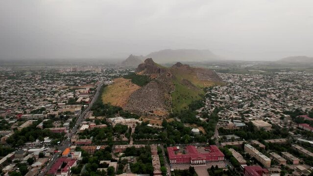 Aerial view of Osh city, Sacred Mountain Sulaiman Too in city centre. Beautiful powerful mountain.