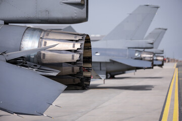Fighter jet exhaust nozzle detail on a lot of fighter airplanes in parking position.