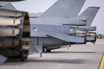 Fighter jet exhaust nozzle detail on a lot of fighter airplanes in parking position.