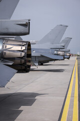 Fighter jet exhaust nozzle detail on a lot of fighter airplanes in parking position.