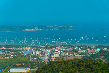 The Big Buddha Phuket viewpoint shows views of the land, the beach, the surrounding boats and the island which is not too far away. Panoramic beauty with a blue sky background during the day